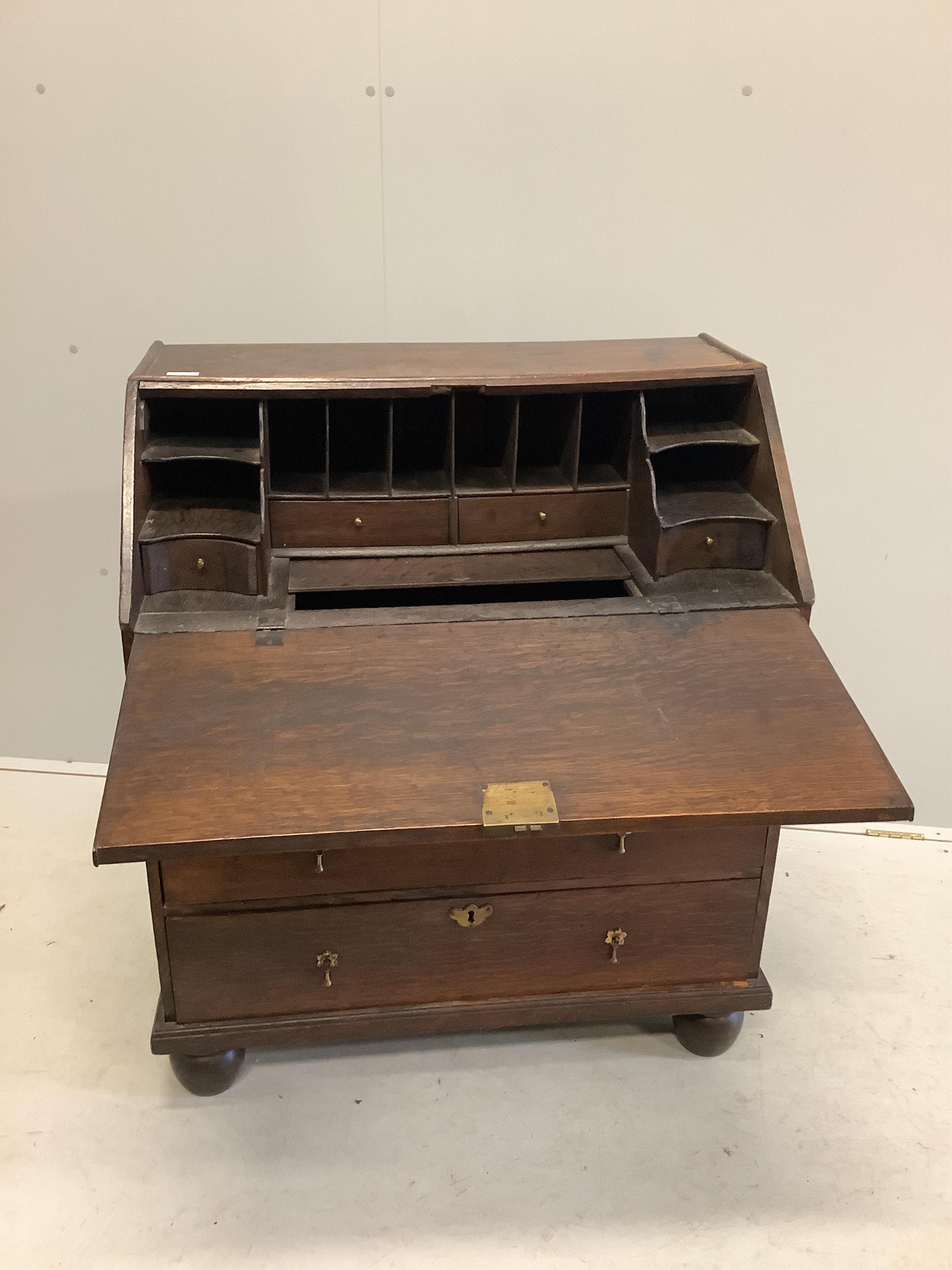 An 18th century oak bureau, width 84cm, depth 52cm, height 98cm. Condition - poor to fair